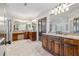 Well-lit primary bathroom featuring dual vanities, granite countertops, and tile flooring at 4541 Gateway Se Ct, Smyrna, GA 30080