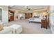 Spacious primary bedroom with tray ceilings, a sitting area, and an en suite bathroom entrance at 4541 Gateway Se Ct, Smyrna, GA 30080