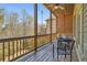 Covered back porch with wood railings and a ceiling fan, perfect for outdoor relaxation at 4541 Gateway Se Ct, Smyrna, GA 30080