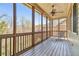 Relaxing screened porch with wood flooring and ceiling fan; perfect for enjoying the outdoors at 4541 Gateway Se Ct, Smyrna, GA 30080