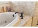 Close up of a white tub with bronze fixtures at 4541 Gateway Se Ct, Smyrna, GA 30080