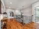 Second floor hallway with hardwood floors, decorative railing, and access to bedrooms at 4541 Gateway Se Ct, Smyrna, GA 30080