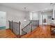 Upstairs hallway with hardwood floors, decorative railing, and ample natural light at 4541 Gateway Se Ct, Smyrna, GA 30080
