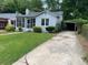 Charming single-Gathering home with a well-maintained lawn and driveway leading to a carport at 1829 Mercer Ave., College Park, GA 30337