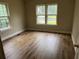 Bright bedroom with laminate floors featuring natural light and a spacious layout at 1829 Mercer Ave., College Park, GA 30337