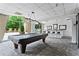 Well lit billiards room has a pool table, carpeted floors, bar seating and access to the outdoor pool at 2479 Peachtree Ne Rd # 305, Atlanta, GA 30305