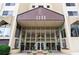 Close-up of a glass-enclosed building entrance with manicured landscaping at 2479 Peachtree Ne Rd # 305, Atlanta, GA 30305
