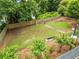Large fenced in dog park with a grassy area and mulch, landscaping, trees and a bench at 2479 Peachtree Ne Rd # 305, Atlanta, GA 30305
