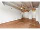 Open living space with hardwood floors and exposed concrete ceilings at 2479 Peachtree Ne Rd # 305, Atlanta, GA 30305