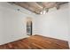 Living space with hardwood floors and an exposed concrete ceiling with a view into the kitchen at 2479 Peachtree Ne Rd # 305, Atlanta, GA 30305