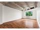Bright living room featuring hardwood floors, an exposed concrete ceiling, and natural light from the window at 2479 Peachtree Ne Rd # 305, Atlanta, GA 30305