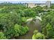 Scenic view of a calm pond, surrounded by trees, lush landscaping, and views of Atlanta in the distance at 2479 Peachtree Ne Rd # 305, Atlanta, GA 30305