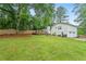Lush backyard with a well-maintained lawn and a charming deck attached to the house at 4120 Valley Wood Nw Dr, Marietta, GA 30064