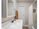 Simple bathroom with white vanity, updated faucet, and shower with a white curtain at 4120 Valley Wood Nw Dr, Marietta, GA 30064