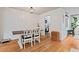 Bright dining area with white chairs and wood table, featuring wood floors and shiplap walls, great for Gathering meals at 4120 Valley Wood Nw Dr, Marietta, GA 30064