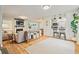 Bright living room featuring wood floors, shiplap accent wall, fireplace, and an open layout perfect for entertaining at 4120 Valley Wood Nw Dr, Marietta, GA 30064