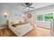 Serene bedroom featuring hardwood floors, a ceiling fan, and ample natural light, creating a relaxing retreat at 4120 Valley Wood Nw Dr, Marietta, GA 30064