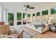 Inviting sunroom filled with natural light, featuring a comfortable seating area with views of the backyard at 4120 Valley Wood Nw Dr, Marietta, GA 30064