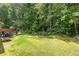 Expansive backyard featuring lush lawn and a patio with outdoor seating, grill and fire pit ideal for entertaining at 4608 Treasure Ct, Forest Park, GA 30297