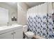 Bathroom with floral shower curtain, and white vanity at 4608 Treasure Ct, Forest Park, GA 30297