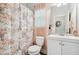 Charming bathroom featuring a floral shower curtain, bright lighting, and a white vanity at 4608 Treasure Ct, Forest Park, GA 30297