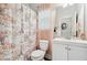 Bathroom with floral shower curtain, window, and white vanity at 4608 Treasure Ct, Forest Park, GA 30297