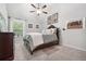 Bedroom with dark wood furniture, ceiling fan, carpet and natural light at 4608 Treasure Ct, Forest Park, GA 30297
