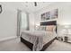 Neutral bedroom features soft carpet, ceiling fan, window, and artwork at 4608 Treasure Ct, Forest Park, GA 30297