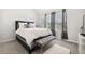 Bedroom with vaulted ceiling, soft carpet, geometric wallpaper and furniture at 4608 Treasure Ct, Forest Park, GA 30297
