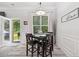 Bright dining area with modern flooring, large window, and access to the outdoor space at 4608 Treasure Ct, Forest Park, GA 30297