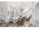 Bright dining room with decorative chandelier, wainscoting, and a bay window at 4608 Treasure Ct, Forest Park, GA 30297