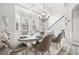Elegant dining room with stylish chandelier, decorative ceiling, and adjacent staircase at 4608 Treasure Ct, Forest Park, GA 30297