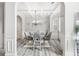 Inviting dining room with coffered ceiling, decorative chandelier, and modern gray flooring at 4608 Treasure Ct, Forest Park, GA 30297