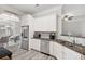 Open kitchen featuring stainless steel appliances, granite countertops, and white cabinetry at 4608 Treasure Ct, Forest Park, GA 30297