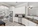 Well-appointed kitchen with stainless steel appliances, granite countertops, and views into dining area at 4608 Treasure Ct, Forest Park, GA 30297