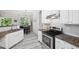 Modern kitchen with granite countertops, white cabinets, and stainless steel appliances at 4608 Treasure Ct, Forest Park, GA 30297