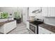 Bright kitchen with white cabinets, granite countertops, stainless appliances, and adjacent dining area at 4608 Treasure Ct, Forest Park, GA 30297