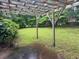 Private backyard features a wooden pergola and lush green grass, perfect for outdoor living at 4889 Fairforest Dr, Stone Mountain, GA 30088