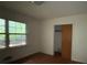 Bedroom featuring wood floors, large window and closet at 4889 Fairforest Dr, Stone Mountain, GA 30088