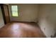 Bright bedroom with hardwood floors, a large window for natural light, and a closet at 4889 Fairforest Dr, Stone Mountain, GA 30088