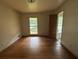 Bedroom with hardwood floors and natural light from large windows at 4889 Fairforest Dr, Stone Mountain, GA 30088