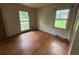 Spacious bedroom with hardwood floors, two windows for natural light, and ample space at 4889 Fairforest Dr, Stone Mountain, GA 30088