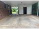 Spacious carport featuring a large concrete pad, enclosed storage, and an opening to the backyard at 4889 Fairforest Dr, Stone Mountain, GA 30088
