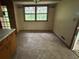 A dining area featuring a window, beige walls, and dull flooring, ready for customization and personalization at 4889 Fairforest Dr, Stone Mountain, GA 30088
