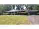 Charming ranch-style home with brick facade, white pillars, a covered porch and side carport at 4889 Fairforest Dr, Stone Mountain, GA 30088
