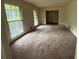 Spacious living room featuring large windows and doorway to dining area at 4889 Fairforest Dr, Stone Mountain, GA 30088