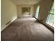 Spacious living room with large windows and open access to the adjacent dining room at 4889 Fairforest Dr, Stone Mountain, GA 30088
