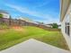 A large backyard with a wood fence, grass, and a small patio at 6100 Semaphore Rdg, Rex, GA 30273
