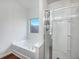Bathroom with tub and shower and a bright window at 6100 Semaphore Rdg, Rex, GA 30273