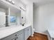 Bathroom with double sink vanity, large mirror, and wood floors at 6100 Semaphore Rdg, Rex, GA 30273